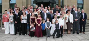 John and Lillian pictured with their guests after their wedding.