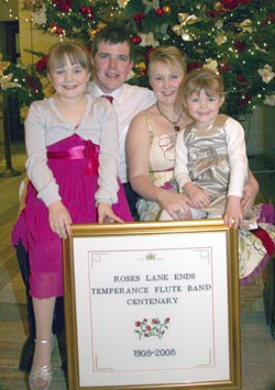 David and Gillian Steele and family pictured with Gillian�s intricate cross-stitched picture.