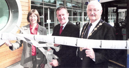 Regional Development Minister Conor Murphy cuts a ribbon of bus tickets, held by Catherine Mason, Translink chief executive, and Mayor of Lisburn City Ronnie Crawford, to open the new Lisburn Bus Centre. US3708-532CD