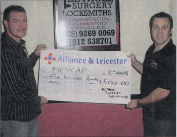 Andrew Wilson presents Noel McKnight with a sponsorship cheque.