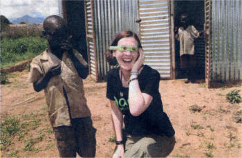 TOILET HUMOUR... Eleanor McEvoy enjoys a light moment with a youngster waiting to use latrines provided by Oxfam to help in the fight against bacteria-borne disease.