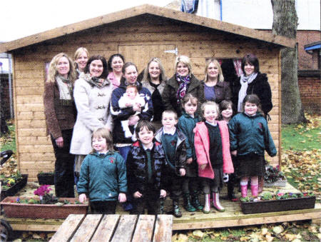 The PTA who held the coffee morning in the school's new garden playhouse to celebrate the opening of the new Outdoor Activity Based Learning Area.