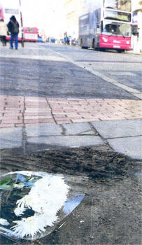 Flowers are laid at the scene where Ciara was killed by a bus on Tuesday in Belfast.