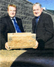 Peter Gough (left), Sales Manager for Allan Block systems at Colinwell Concrete, and Phelim McQuillan, Colinwell's Joint MD, celebrate completion of a huge wall in England.