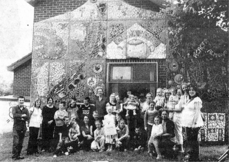 Local community participants pictured in front of the new mosaic, along with Jackie Witherow, Community Development Officer, Arts Council of Northern Ireland and the artists.