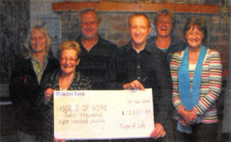 US4008 - tractor cheque - George Megarry (Treasurer) presents Maureen Clark ( Angels of Hope) with a cheque for the road run's proceeds. included is Miriam Ward (Committee member), Ronald Coulter (Chairman), Helen Coulter (Secretary) and Ida McCready (Assistant Treasurer)