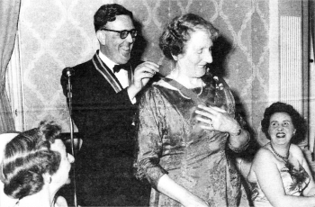 Maurice Bennett presents the Inner Wheel chain of office to Mrs RF McNeight in 1959