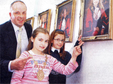 Admiring the portrait of Rebekah MacAuley as the Mayor of Lisburn, are the current Mayor CIIr James Tinsley, Kate and Rebekah.
