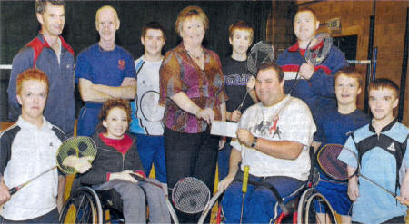 Katherine Morrow (centre), from Northern Bank, hands over a cheque for �1,554, on behalf of the bank's employee charity group, to Michael Smith, from Pan-Disability Lisburn Badminton Club. US4108-533CD