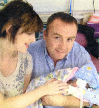 Mags and Barry holding Megan for the very first time.
