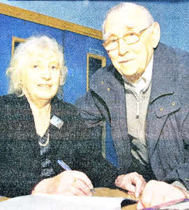 Historian Pearl Finn signs a copy of the new book, Beloved Of My Heart -Little Hillsborough Town, for Billy Gordon. US4909- 519cd