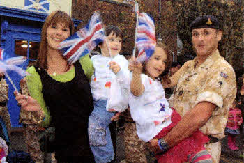 Lynne Cook along with children Lovella (6) & Nathan (3) greet Regimental Sergeant Major (RSM) Warrant Officer 1 (W01) Richard Cook.