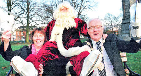 The Mayor of Lisburn, Councillor Allan Ewart launches the Christmas Skating Rink and Santa's Grotto with some help from Councillor Jenny Palmer, Chairman of the Council's Economic Development Committee and Santa Claus.