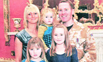 Sergeant Patience with his wife, Dawn, and daughters: Amy (8), Zoe (4) and Sophie (2). Unimpressed by all the excitement little Sophie managed to sleep in mum's arms .... but woke up in time to smile for the Royal visitor! 