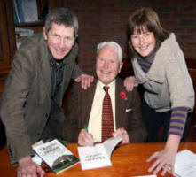 Arthur Chapman signing a copy of his book for his son Stephen and daughter Elizabeth. 