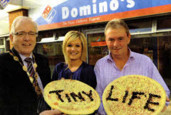 Lisburn City Council Mayor, Councillor Allan Ewart; Mrs Samara Prentice, Community Events Officer, Tiny Life with Mr Adrian Caldwell, Owner of Domino's Pizza, Lisburn.
