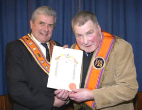Bro Robert Jess, a member of Duke of Schomberg LOL 730, receives his 50-year certificate from the Most Worshipful Robert Saulters (Grand Master).
