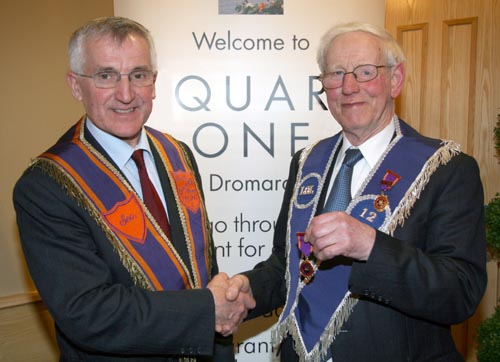 Bro Robert Fee (Past Master) receives his 60-year jewel from Bro Norman Mulholland of Drumreagh LOL 1661.