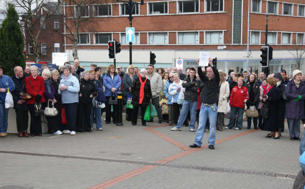 One person in the crowd expresses his views on a poster saying ‘IRA SCUM’.