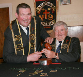 Sir Knt Ian Patterson (RBP 1016) formerly Worshipful District Master of Largymore No 9 District, hands over the gavel to his successor, Sir Knt Tom Wilkinson RBP 172