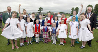 George Ussher (RSPBA President) and Lisburn Mayor, Councillor Allan Ewart Maurice pictured with some of the Highland Dancing competitors at the All Ireland Pipe Band Championships in Lisburn last Saturday (4th July).