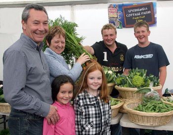 Robbie and Roberta Cowan with their granddaughter Katie and grandniece Amy pictured at the Farmer’s Market in Castle Gardens, buying vegetables from David Harrison and Tommy Patterson of the local Springwell Cottage Farm.