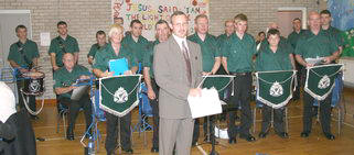 Gary Shields (Conductor) and Lisburn Young Defenders Flute Band pictured getting a rapturous applause at the Pre-Demonstration Dinner.