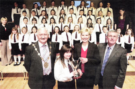 Lisburn City Council Mayor, Councillor Ronnie Crawford, with a pupil from Riverdale Primary School who received the winning trophy on the schools behalf , Dr Janet Gray MBE who presented the trophy and Mr Stanton Sloan, Chief Executive of the South Eastern Education and Library Board.