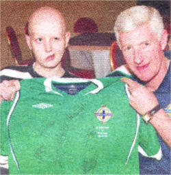 Stephen receives a signed shirt from Northern Ireland Manager Nigel Worthington.