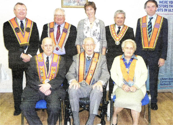 Back row L-R Platform party, Drew Nelson Chairman of OCN, Irwin laggart WM LOL 187, Julie Harrison NI Committee Member of the Big Lottery Fund, Robert Saluters Grand Master of GOLI, Vaughn Hendron Chairman BCES. Front Row L-R Harrison Watson, Jack McComb, Isa Leathem who were in attendance when the Low Quarter Orange Hall was opened in 1938.