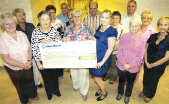 Cathryn Gibson, Community Appeals Officer for Action Cancer, receives a cheque for £25,000 from Action Cancer Lisburn Branch's Norma Bell, which was raised from the beginning of the year US2409.40