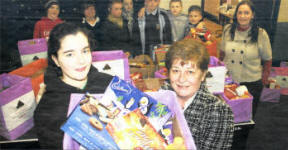 Tammie-Louise Walsh handing a hamper to Tommy Sprat