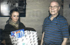 Tammie-Louise Walsh handing a hamper to Tommy Sprat