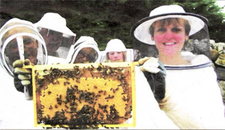 Vanessa Drew from Ballyroney, secretary of Dromore BKA, holds up a good frame of sealed brood at the demonstration.