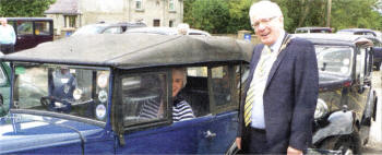  The Mayor of Lisburn, Councillor Allan Ewart looks over the smallest car in the event, a 1934 Austin 7 owned by Ken Irwin and his wife from Hillsborough.