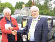  Chairman of The Ulster Pre-War Austin Club, Stanley Cassells welcomes the Mayor of Lisburn, Councillor Allan Ewart to the event.