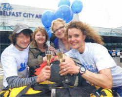 Arlene Spiers, (second right) and Joyce Savage (second left) from the Ulster Cancer Foundation welcome Lynne and Noel Hanna home from their Everest expedition.