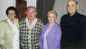 Eric and May McCarthy (centre) with May's twin sister Margaret Wallace and Eric's brother Rodney McCarthy who stood for the couple on their wedding day.