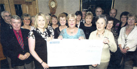 At Rockmount Golf Club, Action Cancer Community Appeals Officer Kathryn Gibson receives a cheque for £55,000 from Lisburn Action Cancer's Norma Bell US0609-401PM Pic by Paul Murphy