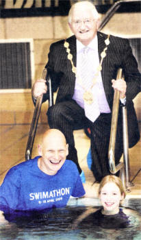 Lisburn Mayor Ronnie Crawford with Duncan Goodhew and Local Swimmer Samanthya Bird at the launch of the Lisburn Swimathon at Lagan Valley Leisureplex. This year's Swimathon is in aid of Marie Curie Cancer Care. US0609-110A0 Picture By: Aidan O'Reilly