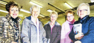 Former Fort Hill College pupils Wilma Bickerstaff, Isobel Gallagher (nee Porter), Mary Sloan (nee Bailey), Leanne Bailey and Madaline Bailey (nee Warring), looking through an old 'memories book' during an evening to mark the college's 50th anniversary. US0509-508cd