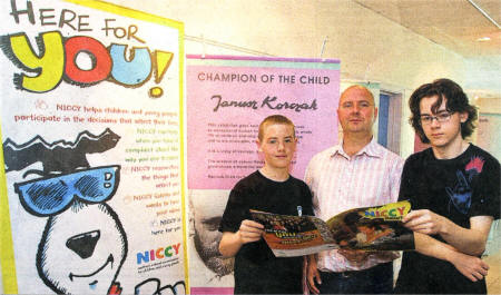 Ken Smyth, participation manager at the Northern Ireland Commissioner for Children, with Andrew Curly and Gerard O'Donnell, from the Young At Art organisation, looking over a new exhibition entitled Champion of the Child at the Island Arts Centre. US2609-560cd