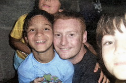 Gordon Armstrong with some of the children in Romania.