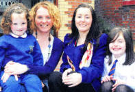 Central Nursery School pupil Casey Connolly with her mother Clare at the service. Included are nursery assistant Michelle McCreedy and P5 pupil Carla Campbell.