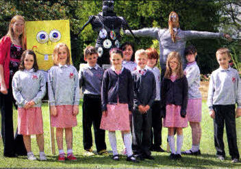Teacher Debbie Lockhart and P5 pupils from Fort Hill lntegrated Primary with scarecrows they worked on together to design and create for the Hillsborough Garden Festival, which takes place from May 21-23. US2010-538cd