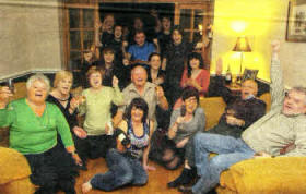 Family members of Aston Merrygold, including his grandmother Kathleen Chambers (left), mother Siobhan Merrygold (third from right, seated on floor) and grandfather Tim Chambers (second right), watch JLS pick up two awards at the Brit Awards on Tuesday.