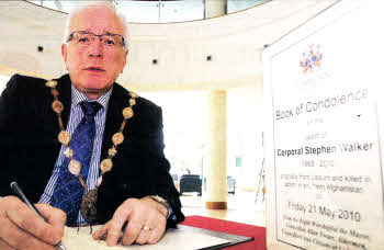 Lisburn Mayor Allan Ewart signs the Book of Condolence for Corporal Stephen Walker which has been opened at Lagan Valley lsland. The Lisburn born Royal Marine was killed on duty in Afghanistan. See page 3. US2110-118A0
	