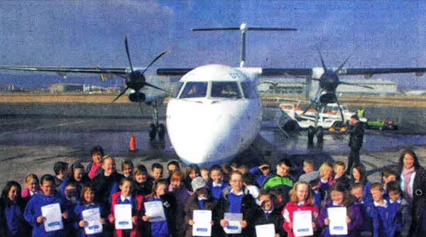 The pupils getting ready to board the plane.
	