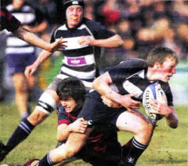 Wallace out half Matthew Godfrey is tackled by BRA fullback Jordan Buchanan during the the first Schools Cup semi-final at Ravenhill. Picture by John Dickson