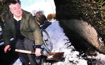 Greg Allman out clearing snow for neighbours despite being in a wheelchair.